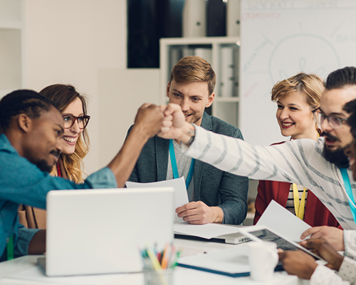 People celebrating over a computer